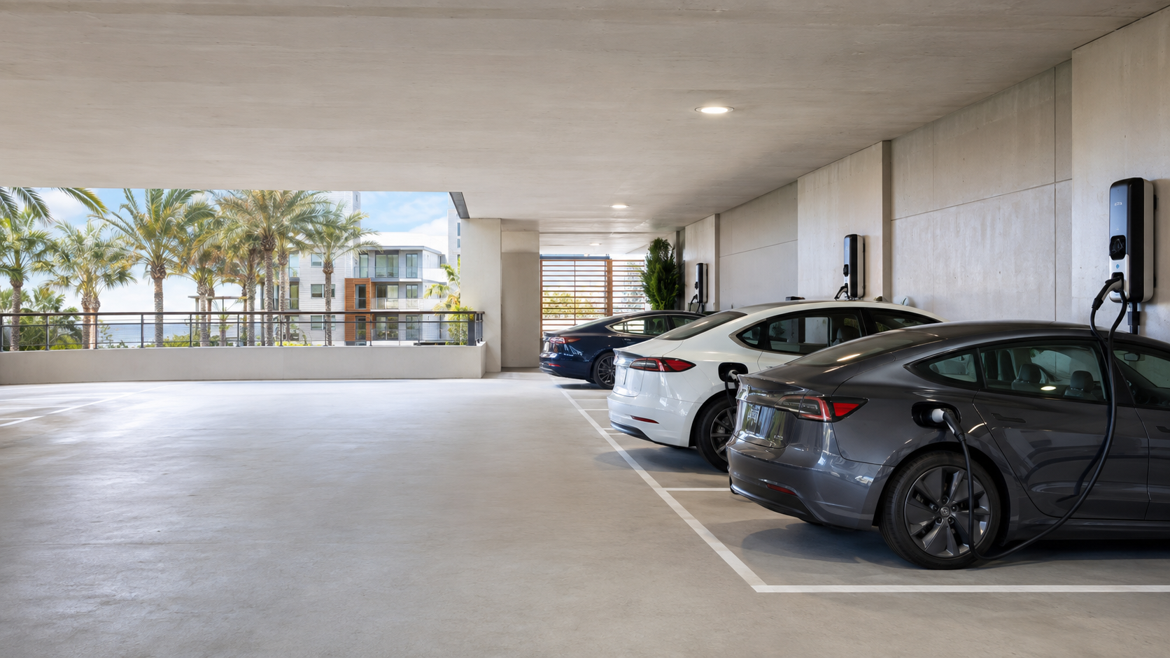 Underground parking garage at an apartment community with EV chargers installed at multiple resident stalls